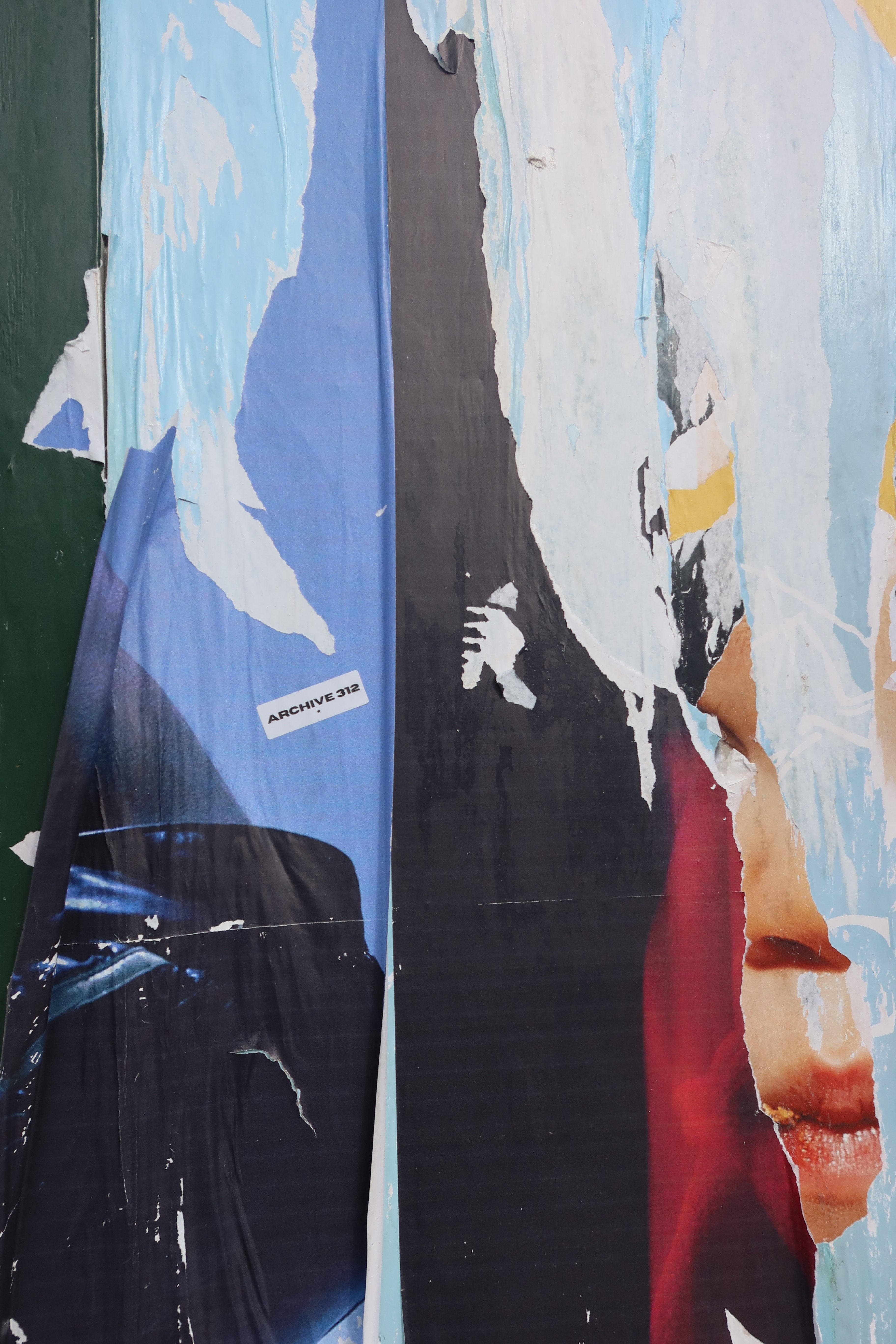 Collage of various printed images on a textured surface with Archive 312 sticket